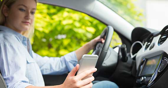  How can I talk safely and lawfully on my phone in the car? 